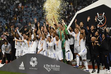 Real Madrid players celebrate winning the Spanish Super Cup final football match between Athletic Bilbao and Real Madrid on January 16, 2022, at the King Fahd International stadium in the Saudi capital of Riyadh.  - Real Madrid won the Spanish Super Cup by beating Athletic Bilbao 2-0 on Sunday as Luka Modric and a Karim Benzema penalty secured a comfortable victory in Saudi Arabia.  (Photo by AFP)