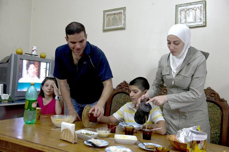 Syrian refugee Talal Al Tinawi, his wife Ghazal and their children Yara and Riad, pictured here at their home in Sao Paulo, are some of the few thousand Syrians to have travelled to Brazil. Nelson Almeida/AFP Photo