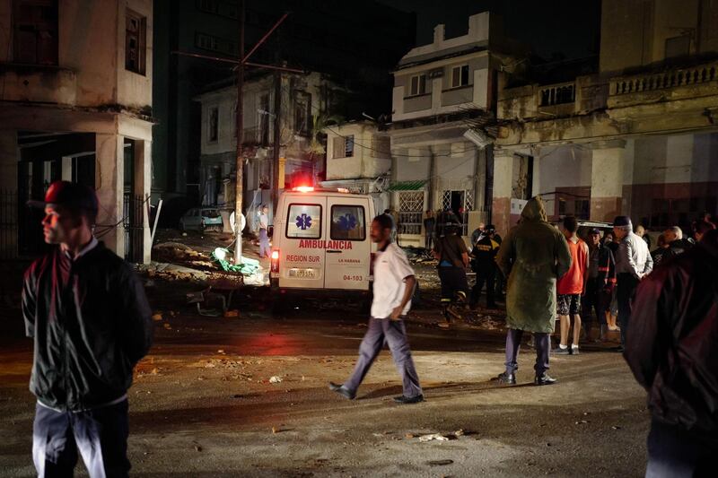 An ambulance drives through the tornado-hit Luyano neighbourhood in Havana early on January 28, 2019. 
AFP