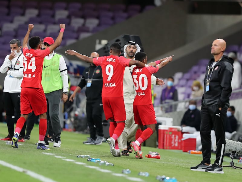 Shabab Al Ahli's Juma celebrates with teammates after scoring.