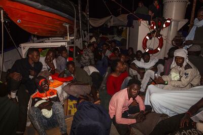 Rescued migrants sit in the search and rescue ship of German aid group Mission Lifeline as the boat remained stranded off Malta with 234 migrants aboard and no port at which to dock after both Italy and Malta refused to give authorization, early Monday, June 25, 2018. Since taking office at the beginning of the month, Italian Interior Minister Matteo Salvini has launched a crackdown on private European-flagged rescue ships. (Mission Lifeline via AP)