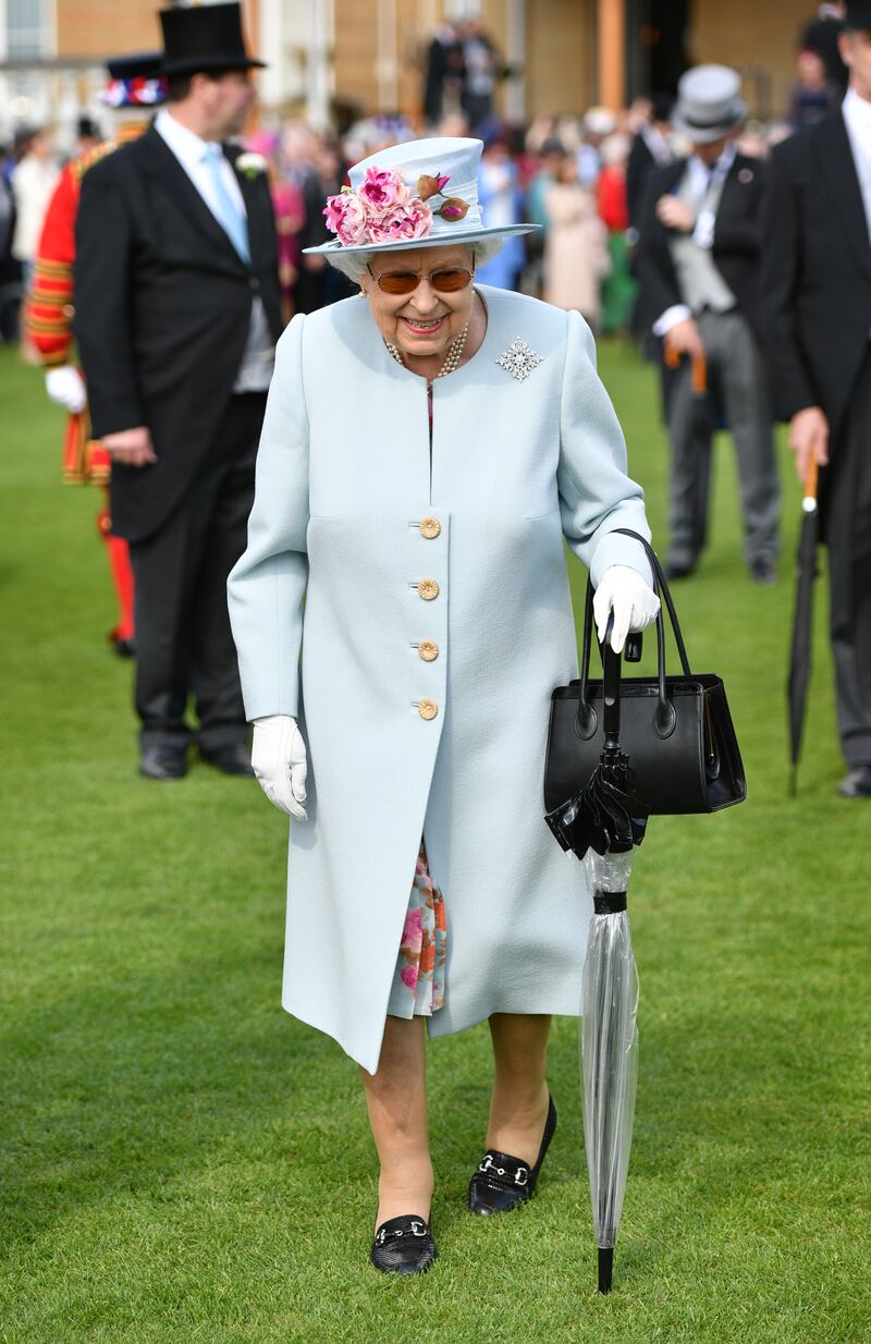 Queen Elizabeth II, in light blue, attends the Royal Garden Party at Buckingham Palace on May 21, 2019, in London, England. Getty Images