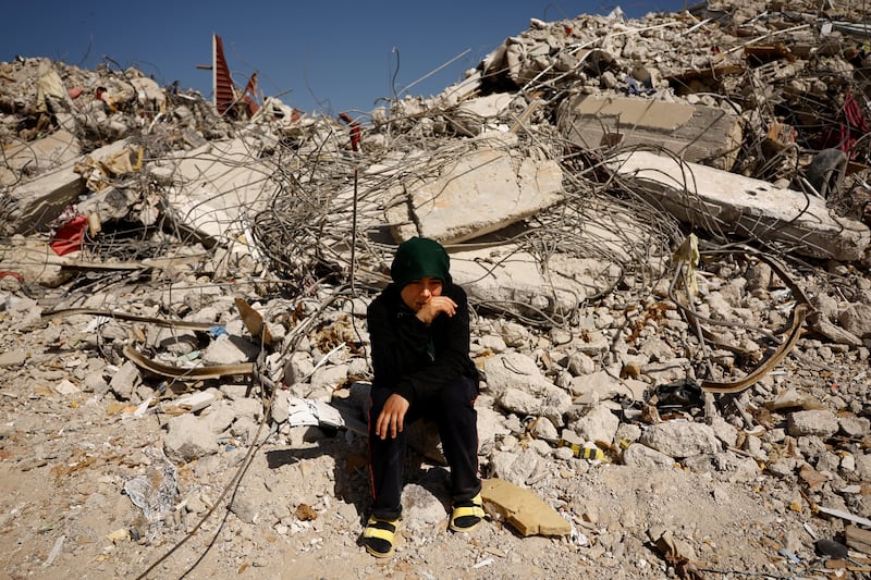 Fatmagul Arslan, 19, visits what is left of her home, where she was trapped for five days with her parents and two siblings, after the earthquake, in Nurdagi, Turkey. Reuters