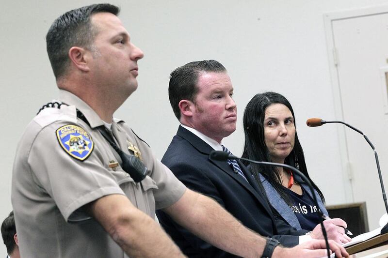 A San Diego traffic court threw out a citation against Cecilia Abadie, right, believed to be the first motorist in the United States ticketed for driving while wearing a Google Glass computer-in-eyeglass device. Also with Ms Abadie are California Highway Patrol officer Keith Odle, left, and lawyer William Concidine. AP Photo/U-T San Diego, John Gastaldo, Pool