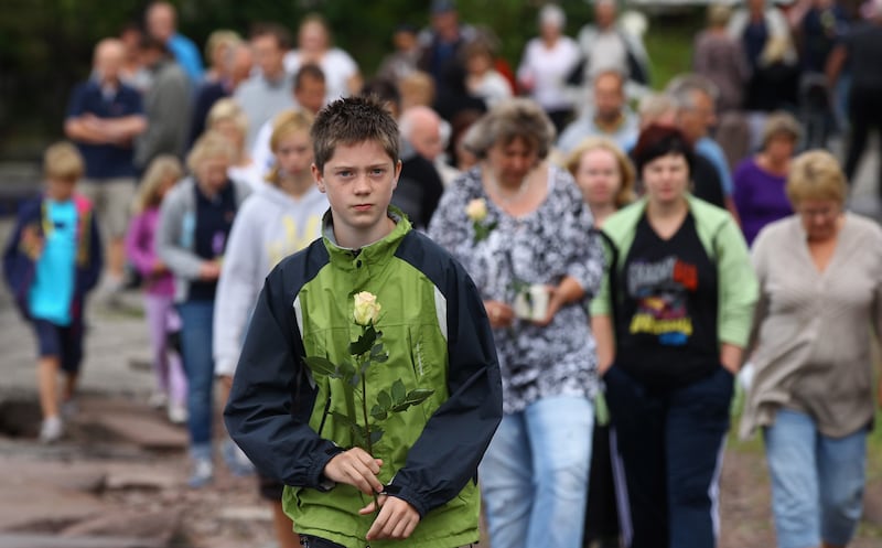 Mourners gather to observe a minute's silence opposite Utoya island on July 25, 2011.