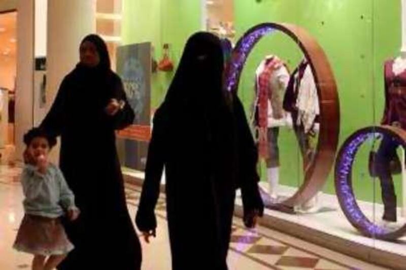 epa01174881 Saudi Arabian women pass a clothes shop at Faysaliya Mall in Riyadh, Saudi Arabia on 16 November 2007. Saudi Arabia will host the third OPEC Summit since the cartel's formation 47 years ago from 17 to 18 November. OPEC rejected calls for a production increase, arguing that more OPEC oil on the markets would not influence high oil prices.  EPA/JAMAL NASRALLAH