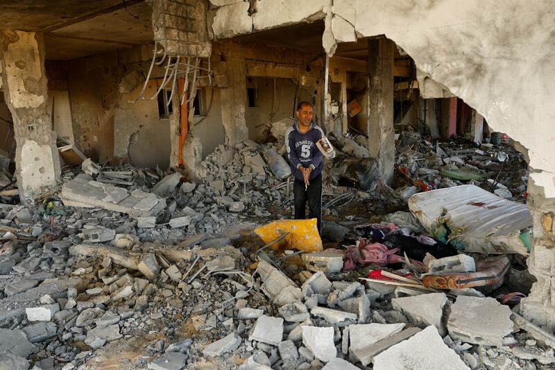 A man walks among debris at the site of an Israeli strike in Khan Younis, amid the ongoing conflict between Israel and Hamas. Reuters