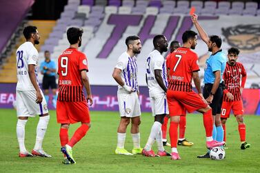 Al Ain's Yahia Nader, centre, is shown the red card during the match against Al Jazira at the Hazza Bin Zayed Stadium. Courtesy PLC