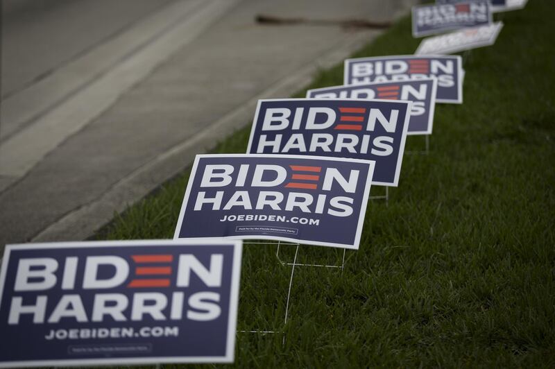 Biden Harris campaign signs are displayed outside an early voting polling location for the 2020 Presidential election in Miami, Florida, U.S., on Monday, Oct. 19, 2020. The Biden campaign and its supporters have booked $15.4 million worth of media advertising on Oct. 19, compared with $6 million booked by the Trump campaign and its backers, according to data by ad-tracking firm Advertising Analytics. Photographer: Marco Bello/Bloomberg