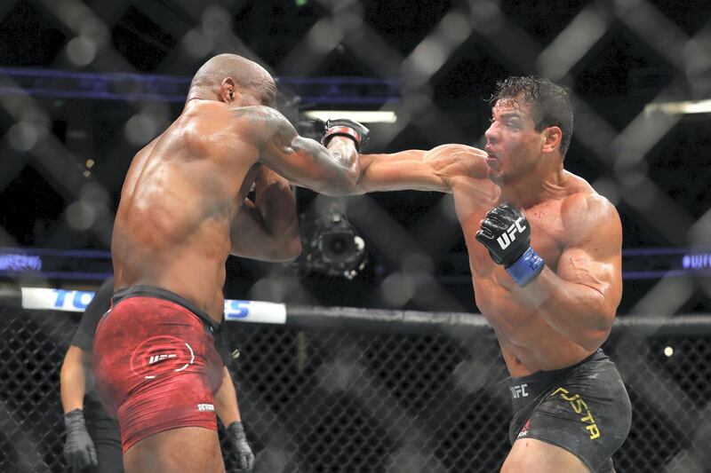 ANAHEIM, CALIFORNIA - AUGUST 17: Paulo Costa throws a punch at Yoel Romero in the third round during their Middleweight Bout at UFC 241 at Honda Center on August 17, 2019 in Anaheim, California.   Joe Scarnici/Getty Images/AFP