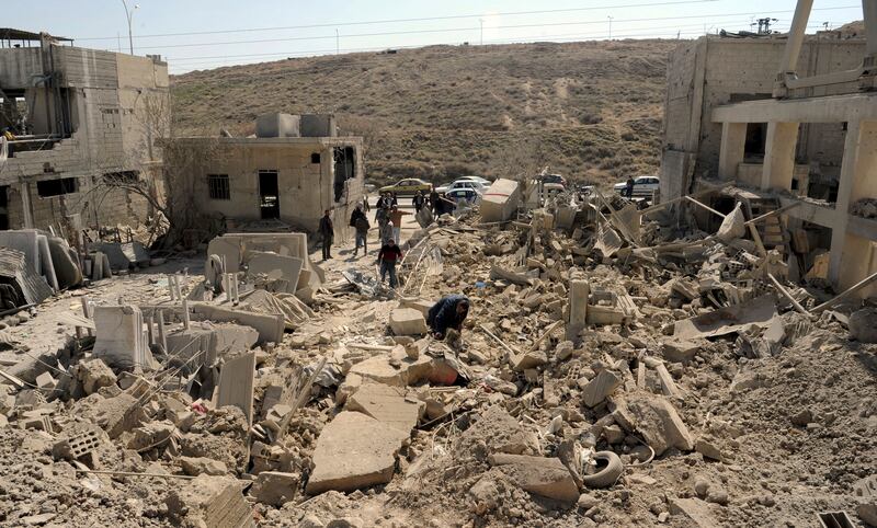 People inspect damage after an Israeli air strike near Damascus, Syria, on March 7. Sana / AP