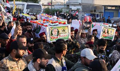 Mourners carry the coffins of Iraq's Kataib Hezbollah fighters who were killed by US air strike in Jurf Al Sakhar, at a funeral in Baghdad. Reuters