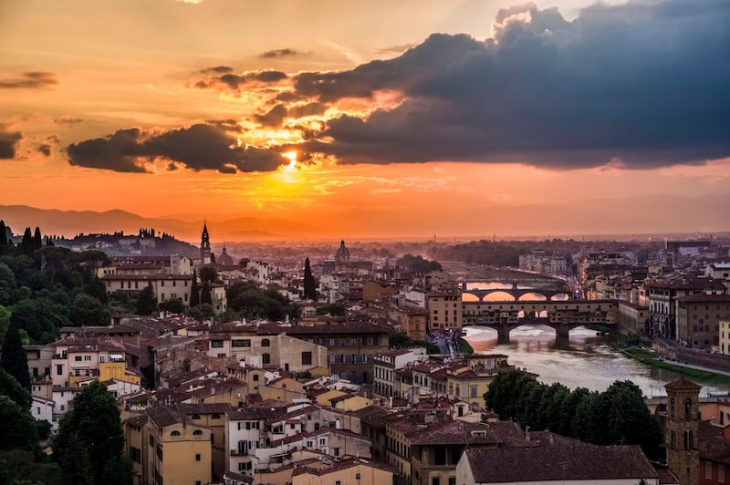 FLORENCE, TUSCANY, ITALY - 2018/05/10: Panoramic aerial view on town from Piazza Michelangelo at sunset, the bridge Ponte Vecchio mirroring in the river Arno. (Photo by Frank Bienewald/LightRocket via Getty Images)