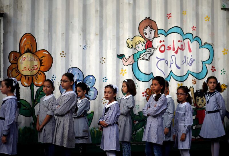 Palestinian schoolgirls queue at an UNRWA-run school, on the first day of a new school year, in Gaza City. Mohammed Salem/Reuters