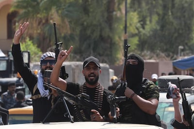 Members of Shiite militias loyal to Shiite cleric and Sadrist movement leader Muqtada al-Sadr withdraw from the Green Zone in Baghdad, Iraq, on August 30. EPA 