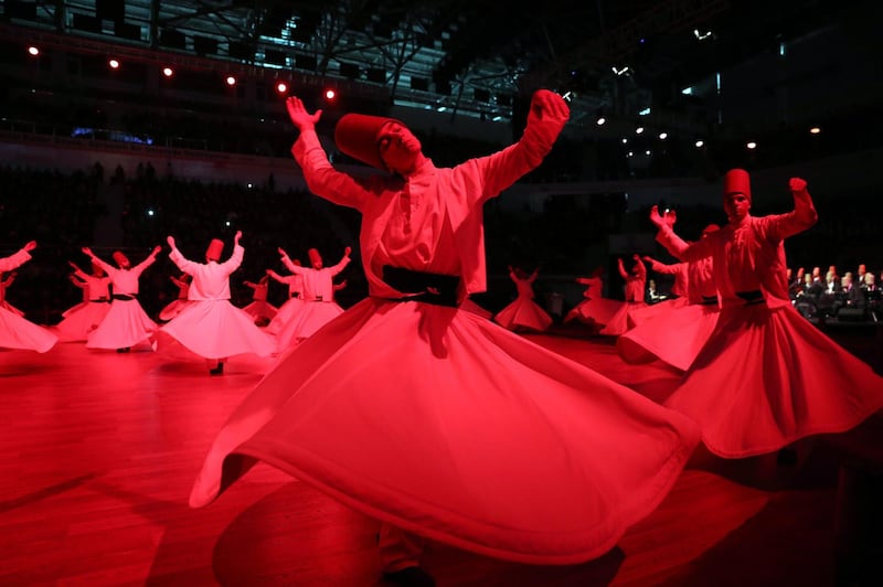 Whirling dervishes perform a "Sema" ritual during a ceremony to mark the 744th anniversary of the death of Mevlana Jalaluddin Rumi, the father of Sufism, at Mevlana Cultural Center in Konya. Adem Altan / AFP Photo
