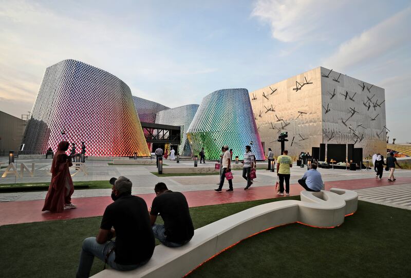 People pass by the Pakistan pavilion, left, and the Bahrain pavilions at the Dubai Expo 2020, in Dubai. Kamran Jebreili / AP Photo