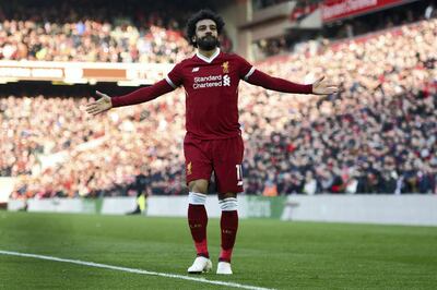 Liverpool's Egyptian midfielder Mohamed Salah celebrates scoring the team's second goal during the English Premier League football match between Liverpool and West Ham United at Anfield in Liverpool, north west England on February 24, 2018. / AFP PHOTO / Oli SCARFF / RESTRICTED TO EDITORIAL USE. No use with unauthorized audio, video, data, fixture lists, club/league logos or 'live' services. Online in-match use limited to 75 images, no video emulation. No use in betting, games or single club/league/player publications.  / 