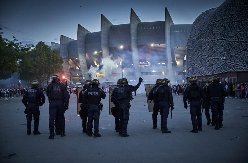 French Riot police face PSG fans during confrontation outside Parc de Princes stadium. Getty