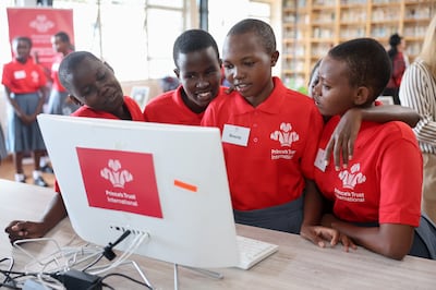 Students look at a computer monitor ahead of the arrival of King Charles III at a Prince's Trust International enterprise in Nairobi, Kenya. PA