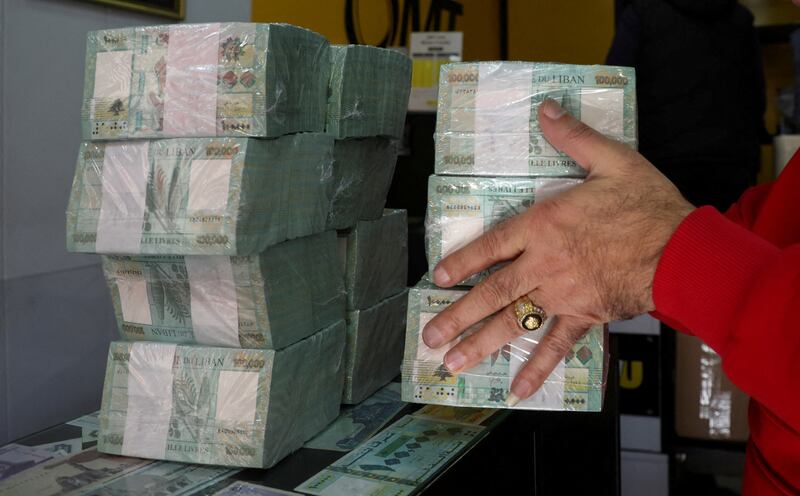 A money exchange vendor holds Lebanese pound banknotes at a shop in Beirut, Lebanon. Reuters