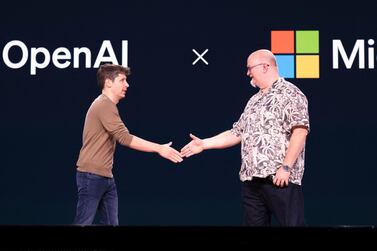 OpenAI chief executive Sam Altman, left, shakes hands with Microsoft chief technology officer Kevin Scott at a conference at Microsoft headquarters in May, AFP