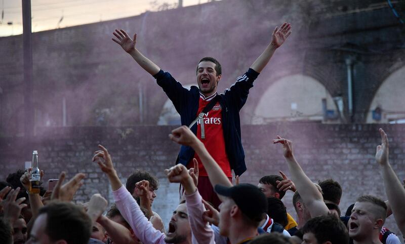 Arsenal fans celebrate outside the Emirates stadium in north London. AFP