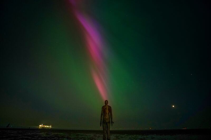 The aurora borealis over Crosby Beach, Liverpool, northern England. PA