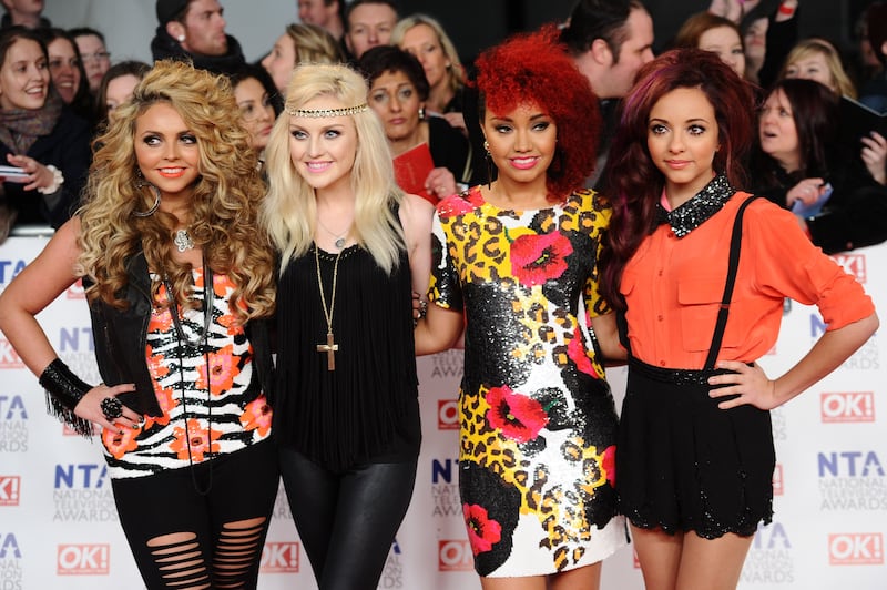 Jesy Nelson, in slashed leggings, a flower-print top and leather waistcoat, with her Little Mix bandmates at the National Television Awards 2012 in London on January 25, 2012