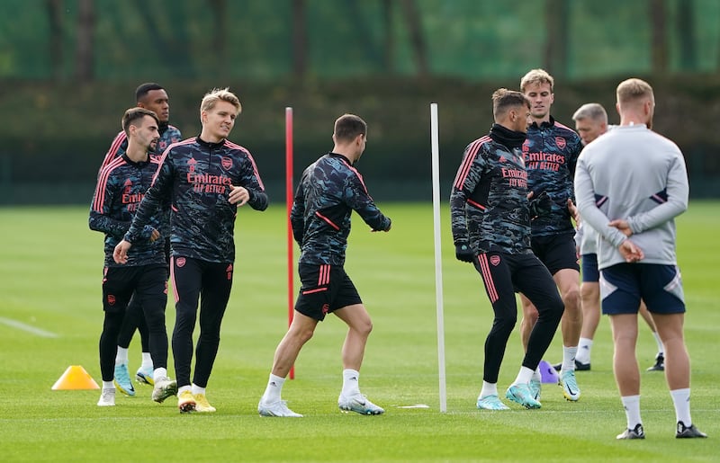 Martin Odegaard with Arsenal teammates during training. PA