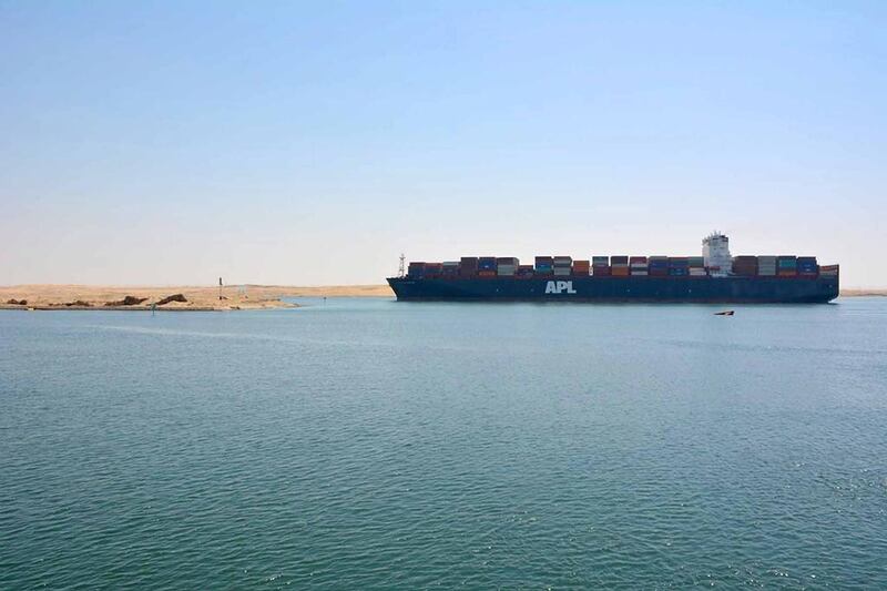 A container vessel passes through the Suez canal, which has generated 5 per cent more revenue for the Egyptian government since it was expanded to add a second lane five years ago. The UAE's National Marine Dredging Company worked on the upgrade. Courtesy NMDC
