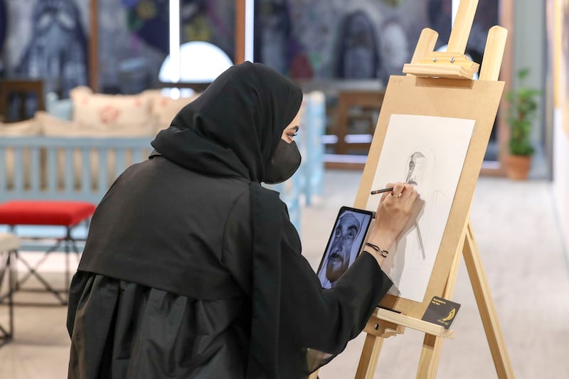 An Emirati artist sketches a portrait of Sheikh Zayed, the Founding Father.