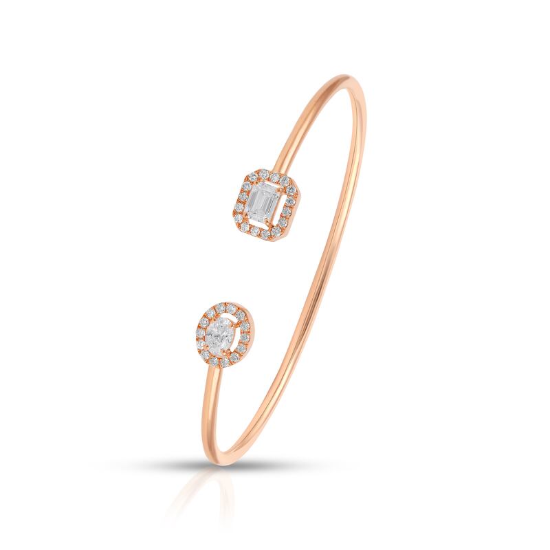 An open bangle in rose gold with single solitaire emerald-cut and oval-cut diamonds; Dh11,000, from Evermore Diamonds.