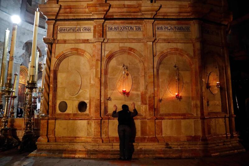 A Christian worshipper prays inside the Church of the Holy Sepulchre in Jerusalem after it reopened on February 28, 2018, following a three-day closure to protest against Israeli tax measures and a proposed law.
Jerusalem's Church of the Holy Sepulchre, seen by many as the holiest site in Christianity, reopened on February 28 after a three-day closure to protest against Israeli tax measures and a proposed law. / AFP PHOTO / THOMAS COEX