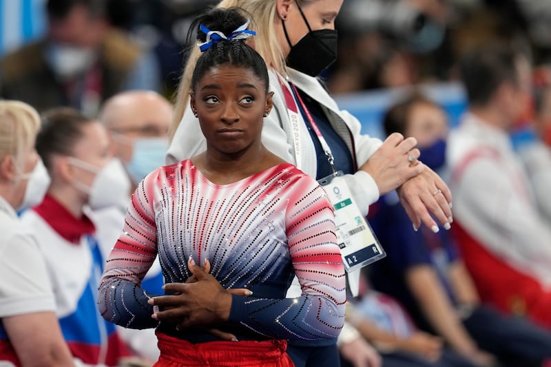 Simone Biles, of the United States, looks at the score after her performance on the balance beam during the artistic gymnastics women's apparatus final .