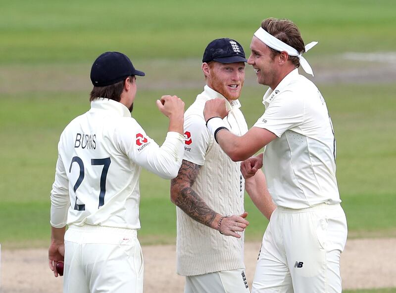 England's Stuart Broad, right, celebrates with Ben Stokes, centre, and Rory Burns after taking the wicket of West Indies' Roston Chase during day two of the third Test at Emirates Old Trafford in Manchester. PA