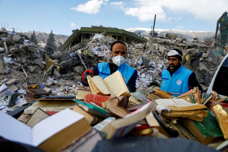 People find copies of the Quran in piles of rubble, following the deadly earthquake in Kahramanmaras, Turkey. Reuters