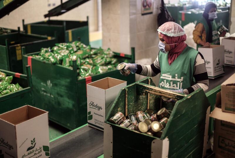 Workers of Egyptian non-governmental organisation Egyptian Food Bank prepare cartons with foodstuffs to distribute to people who lost their jobs in the Egyptian capital Cairo. AFP