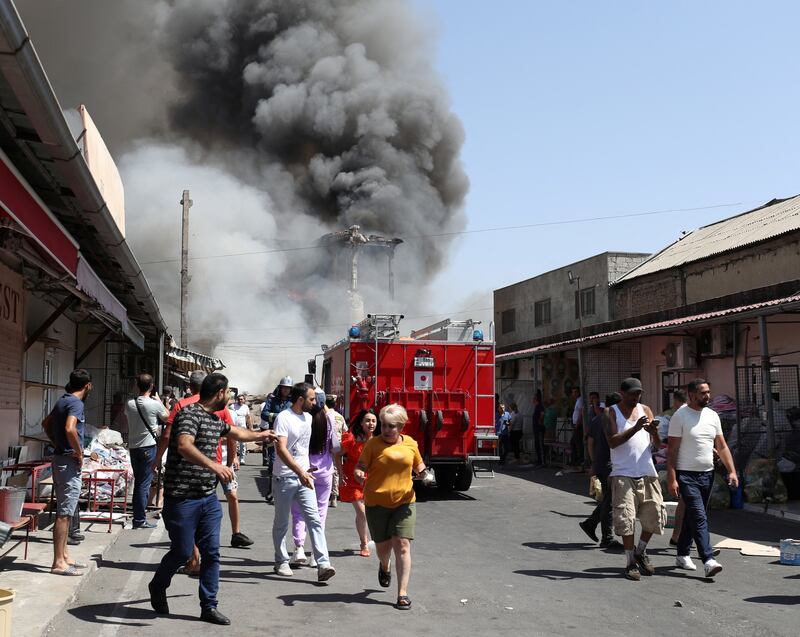 A pall of smoke rises into the sky from the explosions and blaze. Reuters