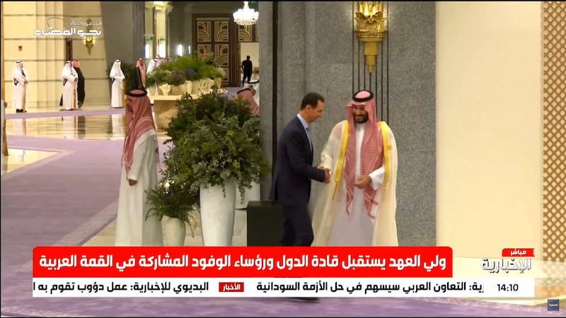 Prince Mohammed greets Mr Al Assad at the Arab League summit in Jeddah. 