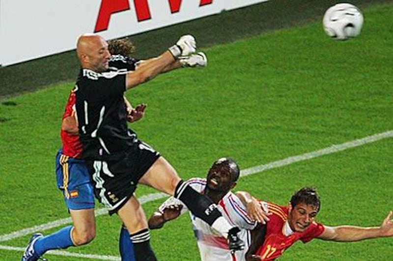 France's keeper Fabien Barthez rises above a crowd of players to clear the ball during the 2006 World Cup quarter-final between France and Spain in Hanover, Germany, which France won 3-1.