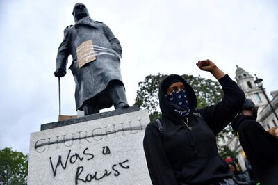 FILE PHOTO: A demonstrator reacts infront of graffiti on a statue of Winston Churchill in Parliament Square during a Black Lives Matter protest in London, following the death of George Floyd who died in police custody in Minneapolis, London, Britain, June 7, 2020. REUTERS/Dylan Martinez     TPX IMAGES OF THE DAY - RC2G4H9061BN/File Photo