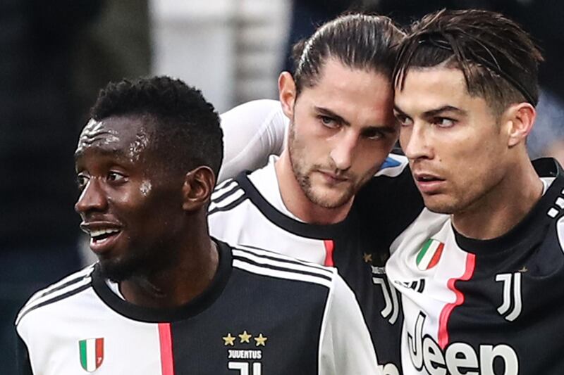 Juventus forward Cristiano Ronaldo celebrates with Blaise Matuidi (L) and Adrien Rabiot. AFP