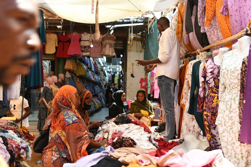 Sudanese people shop at the market. EPA