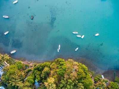 Mauritius, Riviere Noire, La Gaulette, Boats on the water, drone view. Getty Images