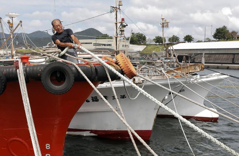 A fisherman tighten a rope to anchor his fishing boat with his colleague's boats in preparation for powerful typhoon Haishen in Makurazaki, Kagoshima Prefecture, southwestern Japan.  EPA