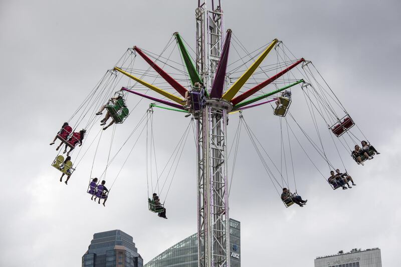 Visitors ride a swing in the central business district of Singapore. Bloomberg
