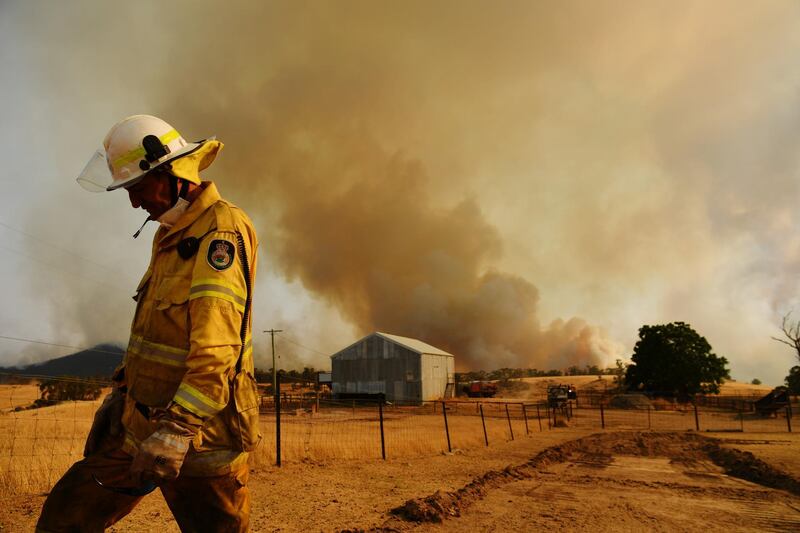 A Rural Fire Service firefighter Trevor Stewart views a flank of a fire in Tumburumba, Australia.  Getty