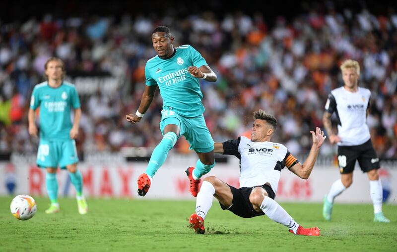 Real Madrid defender David Alaba skips over a challenge from Valencia defender Gabriel Paulista. Getty Images