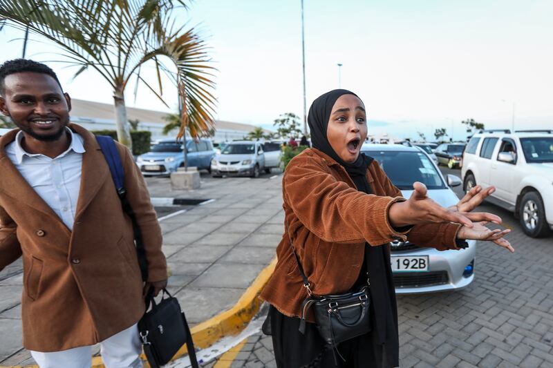 Kenyan student Hubbi Abdirahman greets relatives in Nairobi after she was evacuated from Sudan. EPA